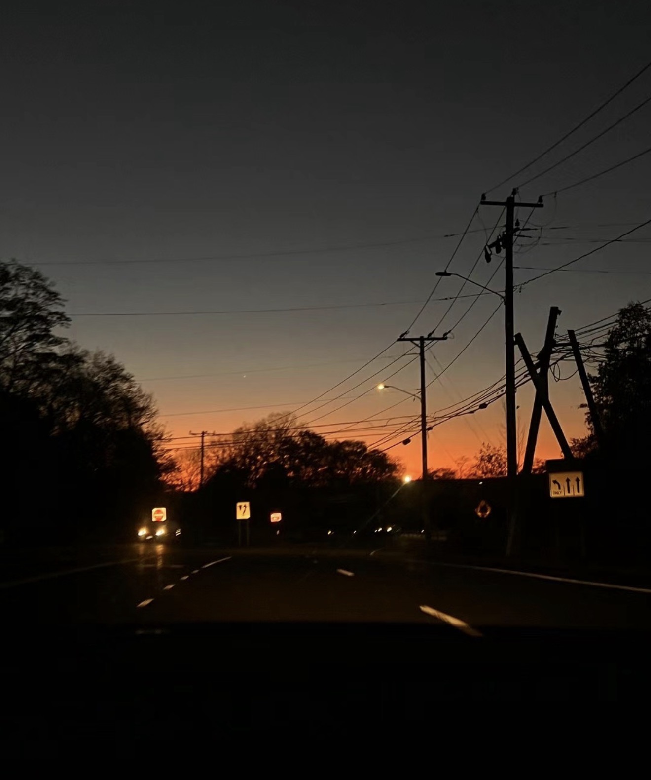 A road fading into an orange dusk