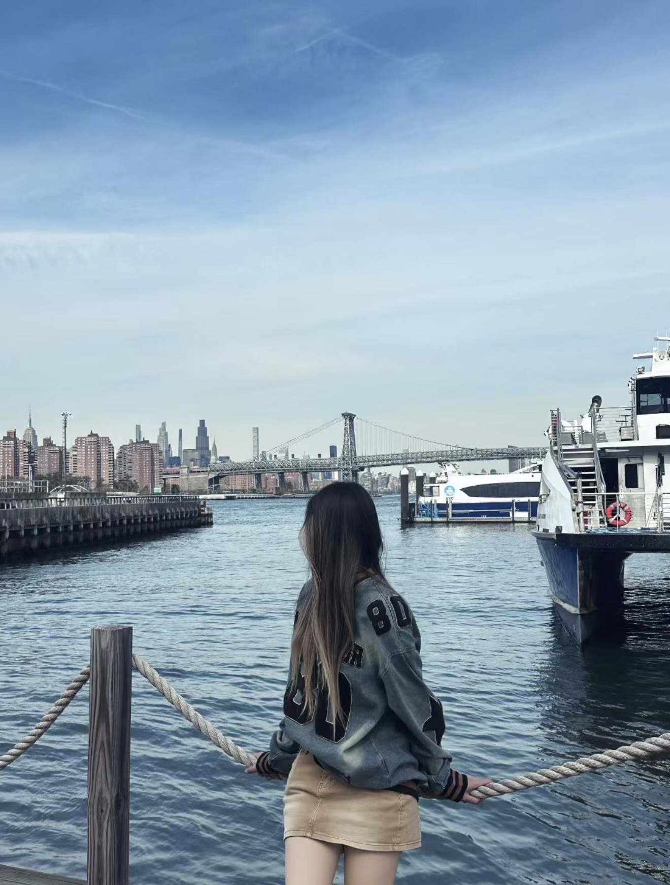 Angel looking across the water toward the city